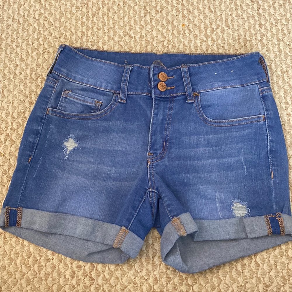 Medium wash denim Junior size 5. Midi length with ripped details.